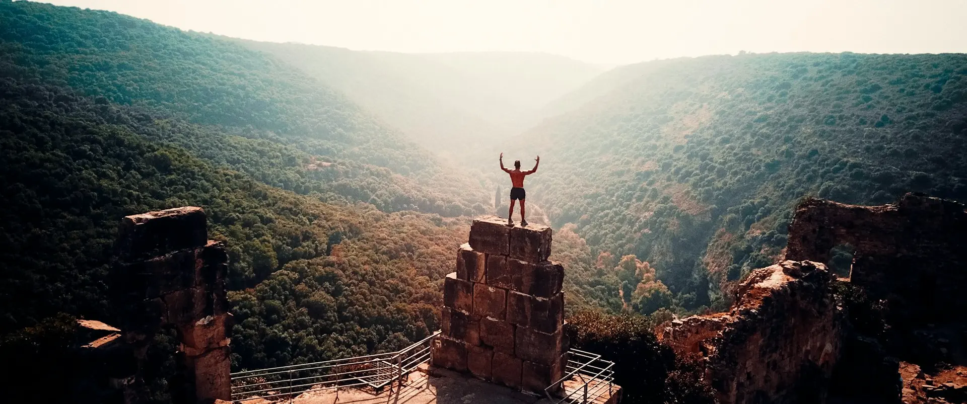 person standing on brown concrete building To show goal achieveding during daytime