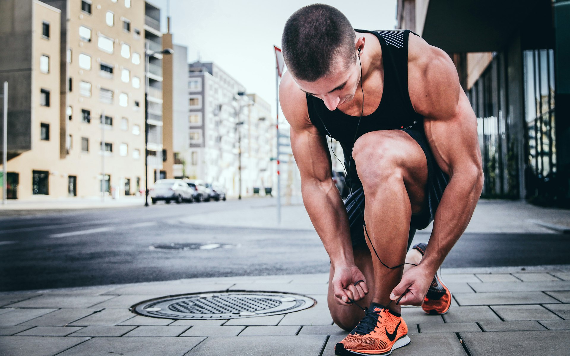 Workout couch tying his shoes